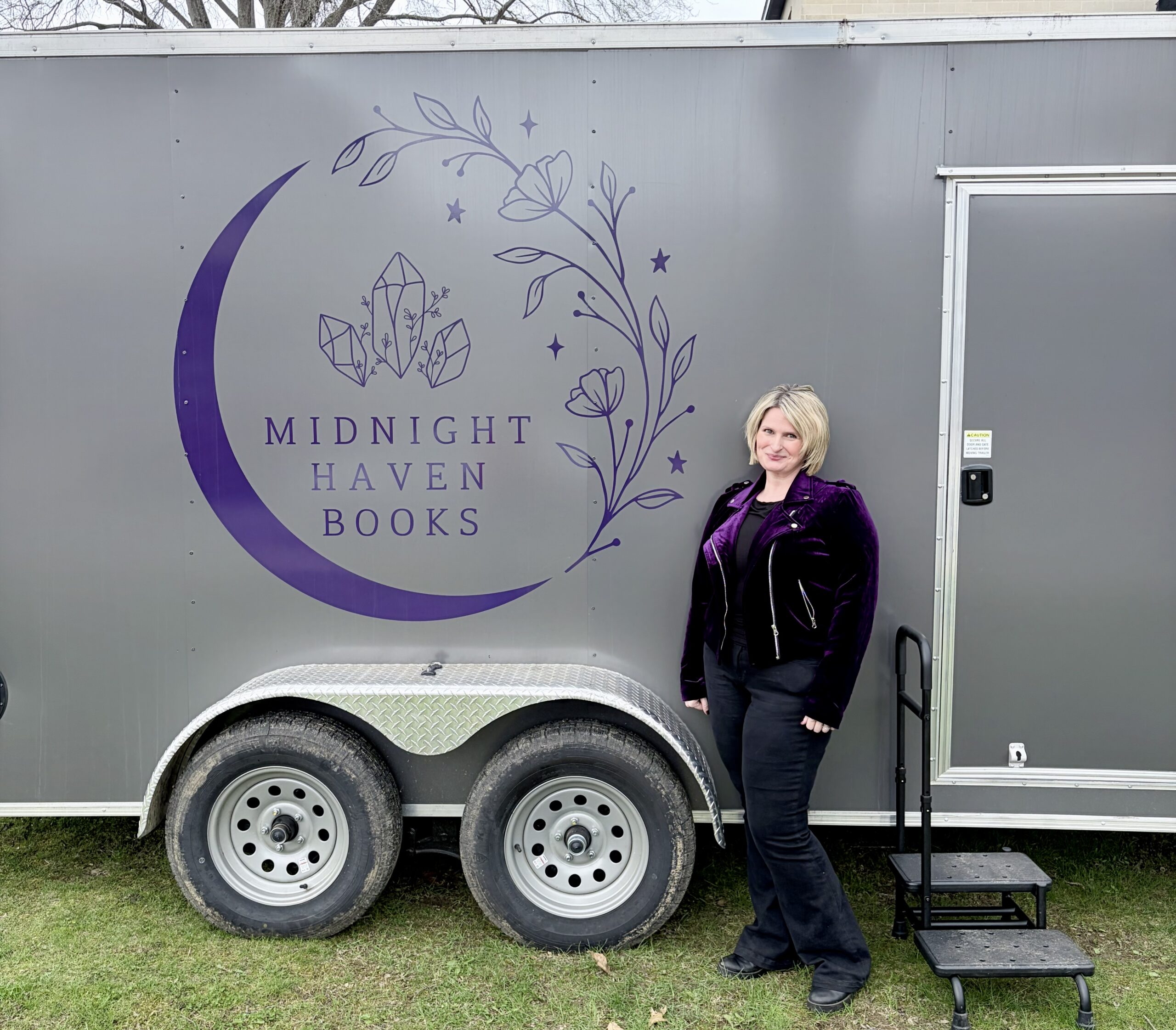 T.L. Johnson standing beside the Midnight Haven Books mobile bookshop trailer in West Virginia